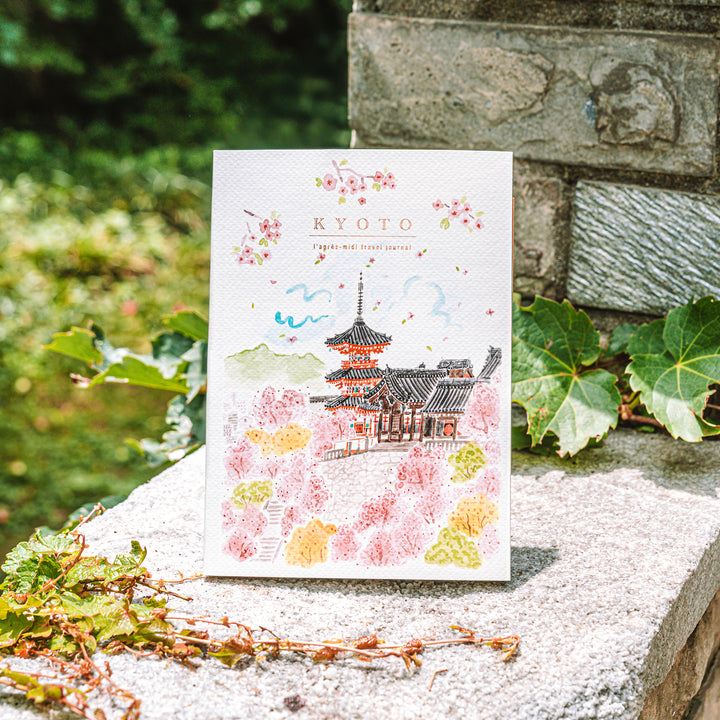 Journal with Kyoto illustration on a stone surface with greenery