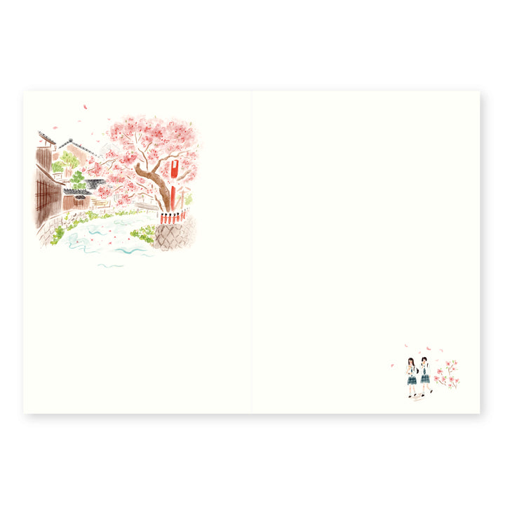 An off-white rectangular inner print featuring a delicate watercolor-style illustration in the upper left of a cherry blossom tree in pink, with a narrow street, buildings, and a small couple at the lower right.