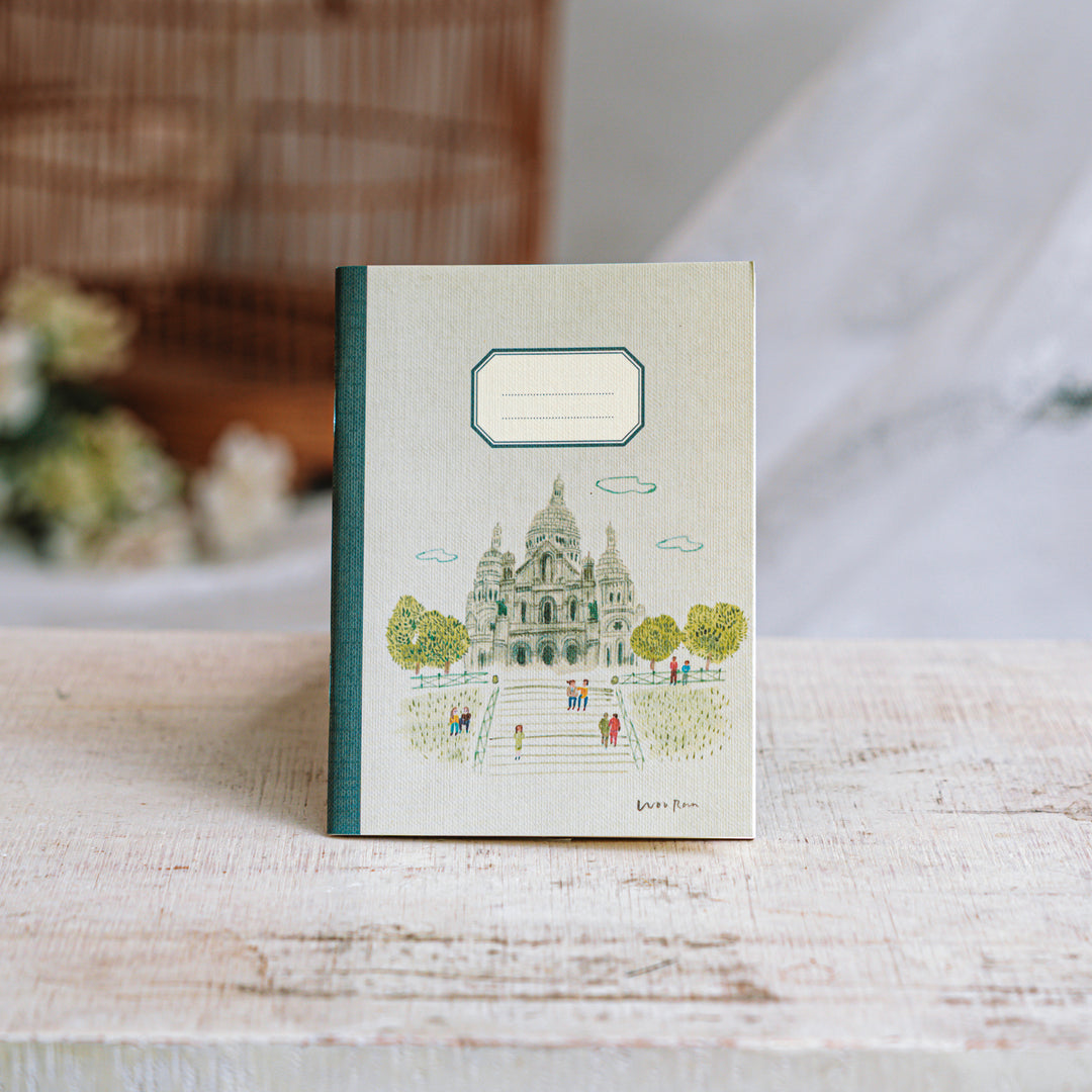 Notebook with a design of a famous landmark on a wooden surface