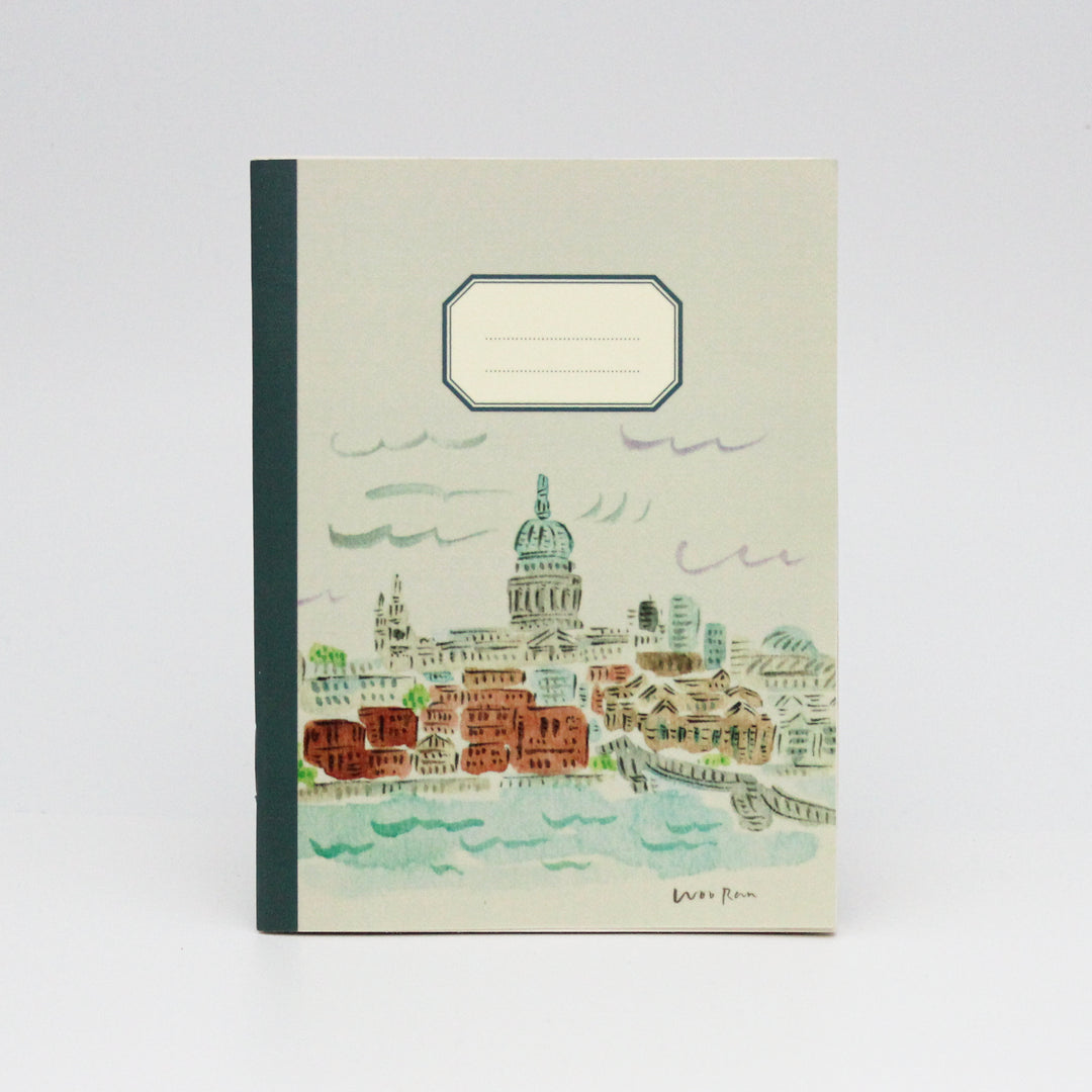 Notebook with a cityscape illustration on the cover