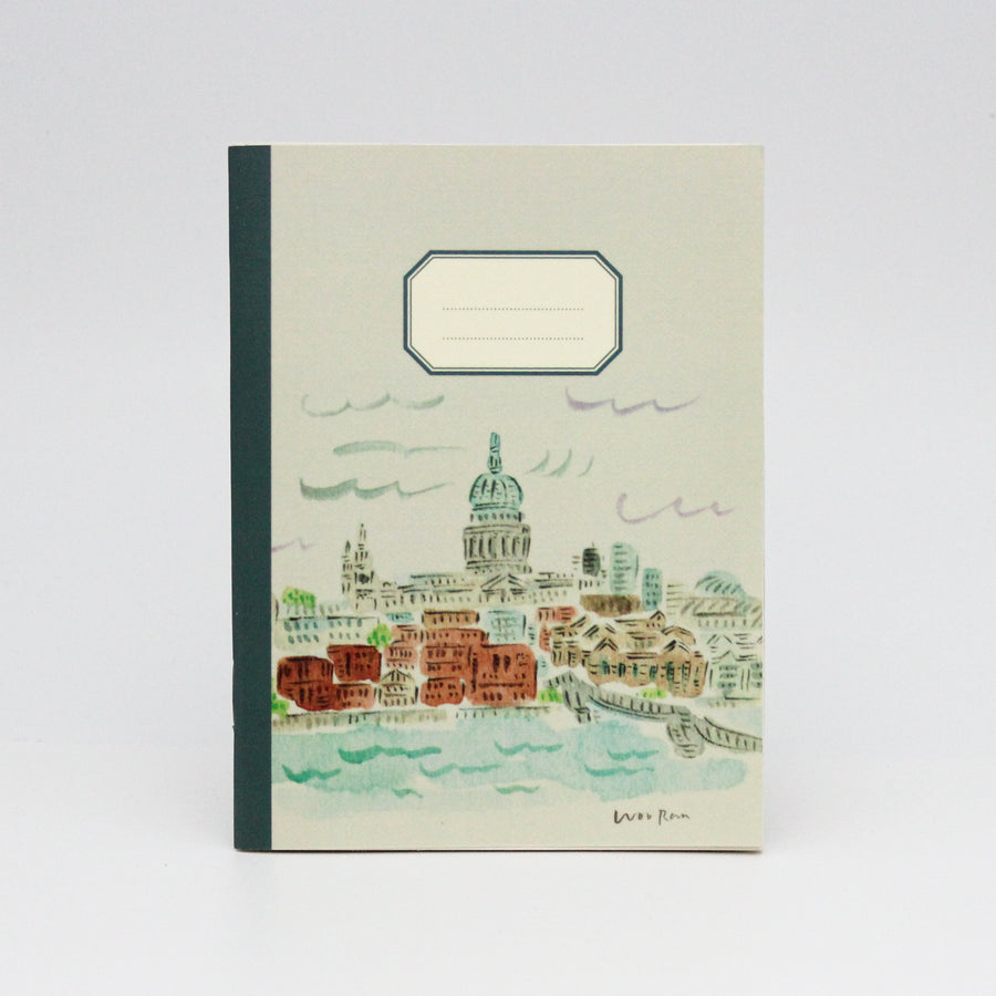 Notebook with a cityscape illustration on the cover