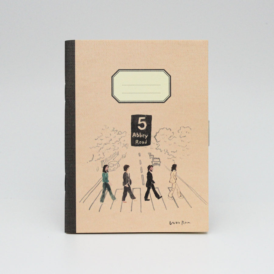 Notebook with '5 Abbey Road' design on a beige background