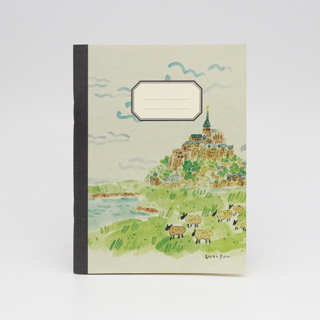 Notebook with a scenic illustration of a village on a hillside.