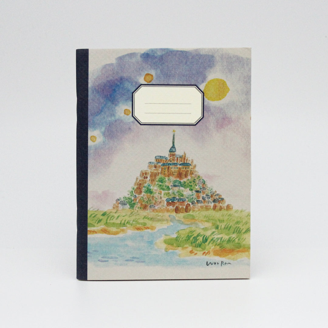 Notebook with a colorful illustration of a castle on a hill against a blue sky with clouds.