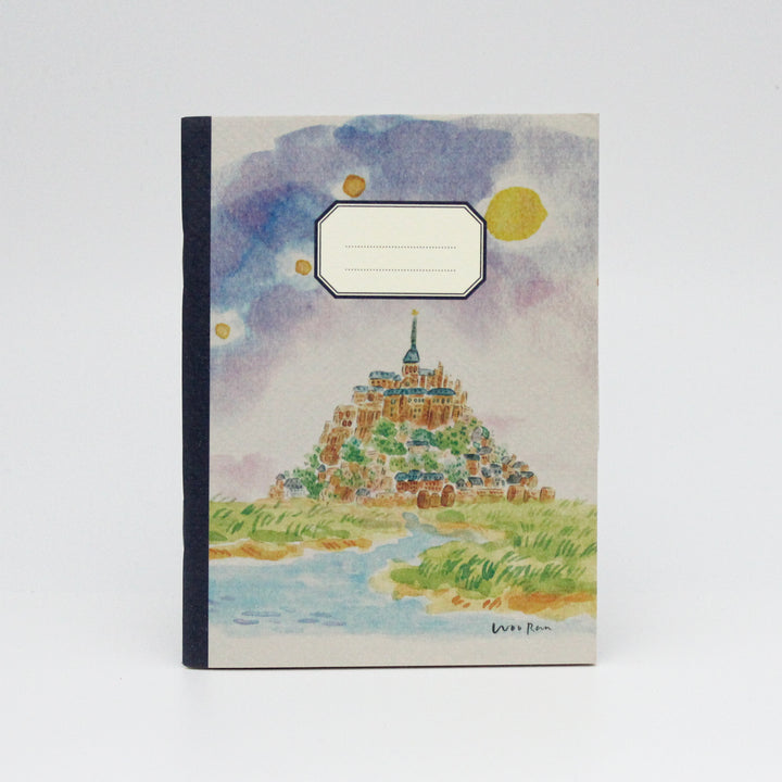 Notebook with a colorful illustration of a castle on a hill against a blue sky with clouds.