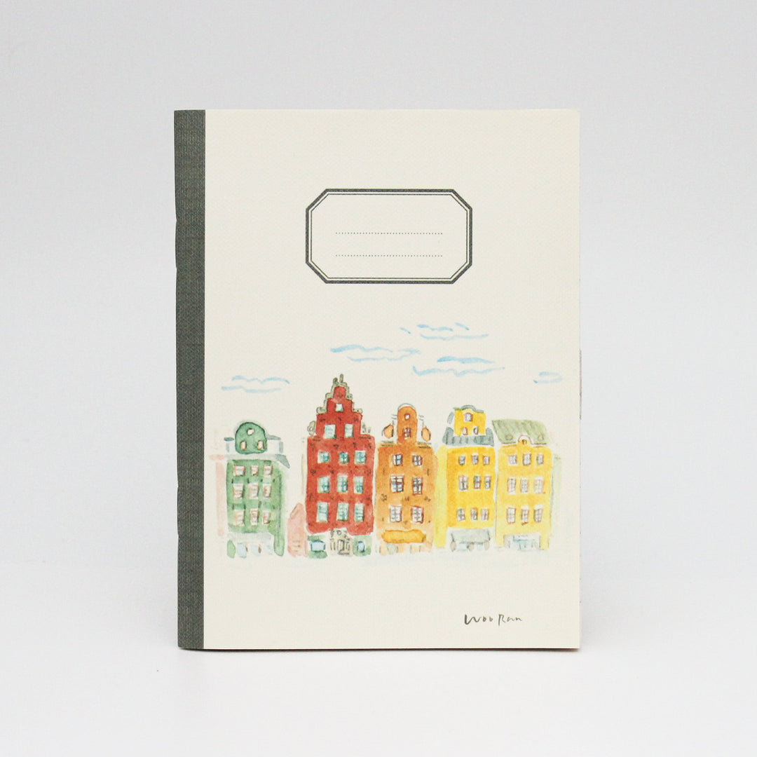 Notebook with colorful building illustration on a white background