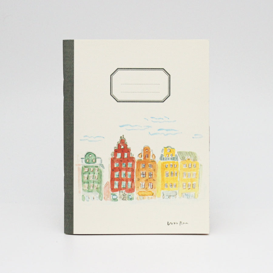 Notebook with colorful building illustration on a white background