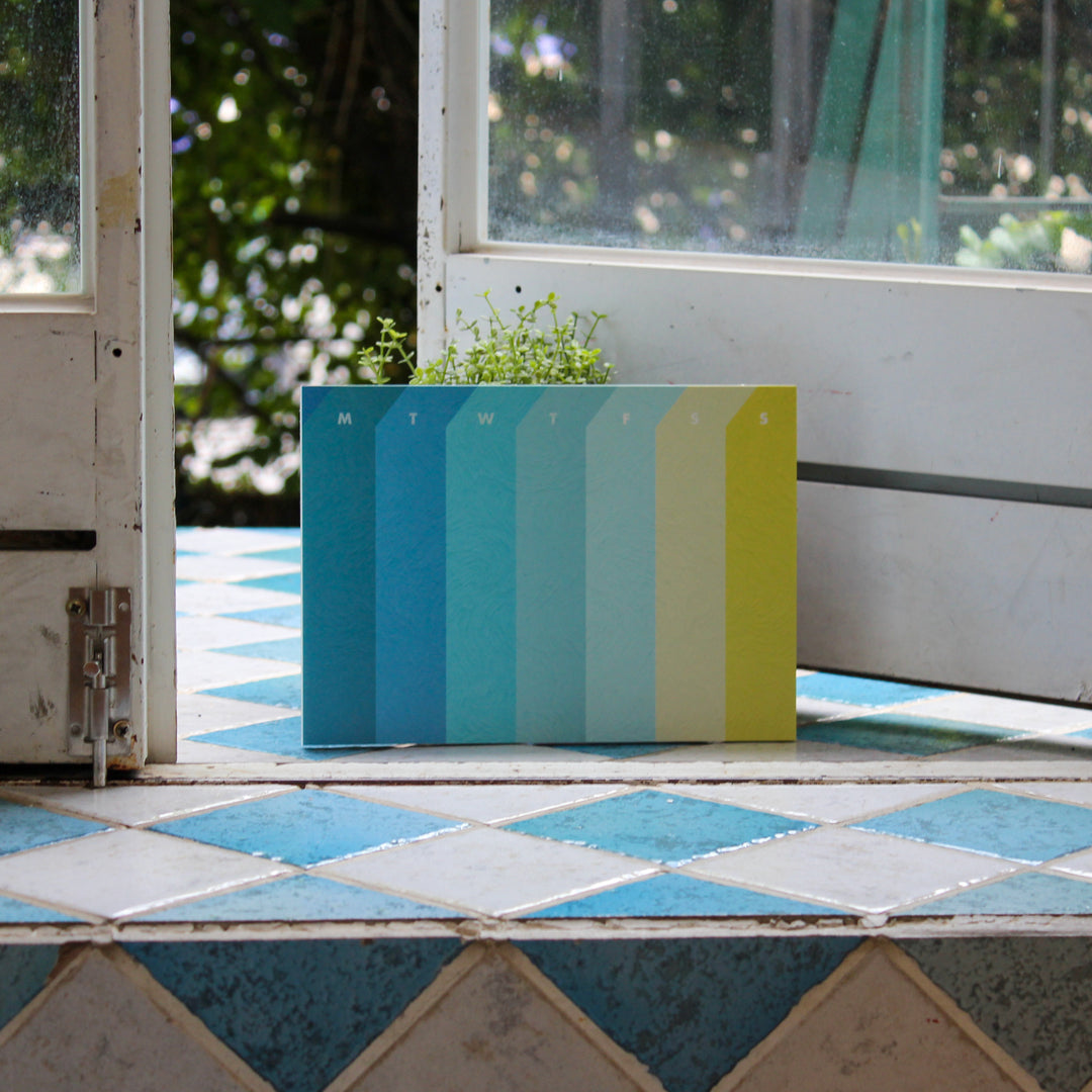 weekly desk pad featuring Van Gogh’s artwork placed on the floor with a door open