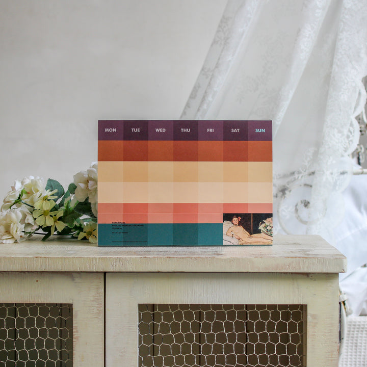 Monthly deskpad with Manet's artwork on the white shelf